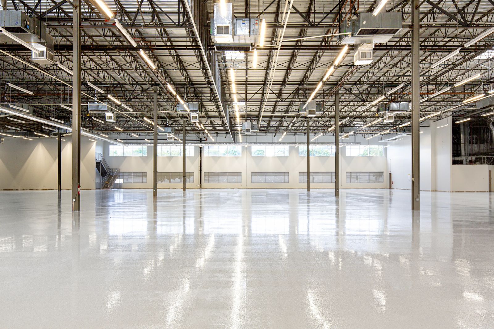 Finished glossy epoxy floor in a large garage-style commercial space